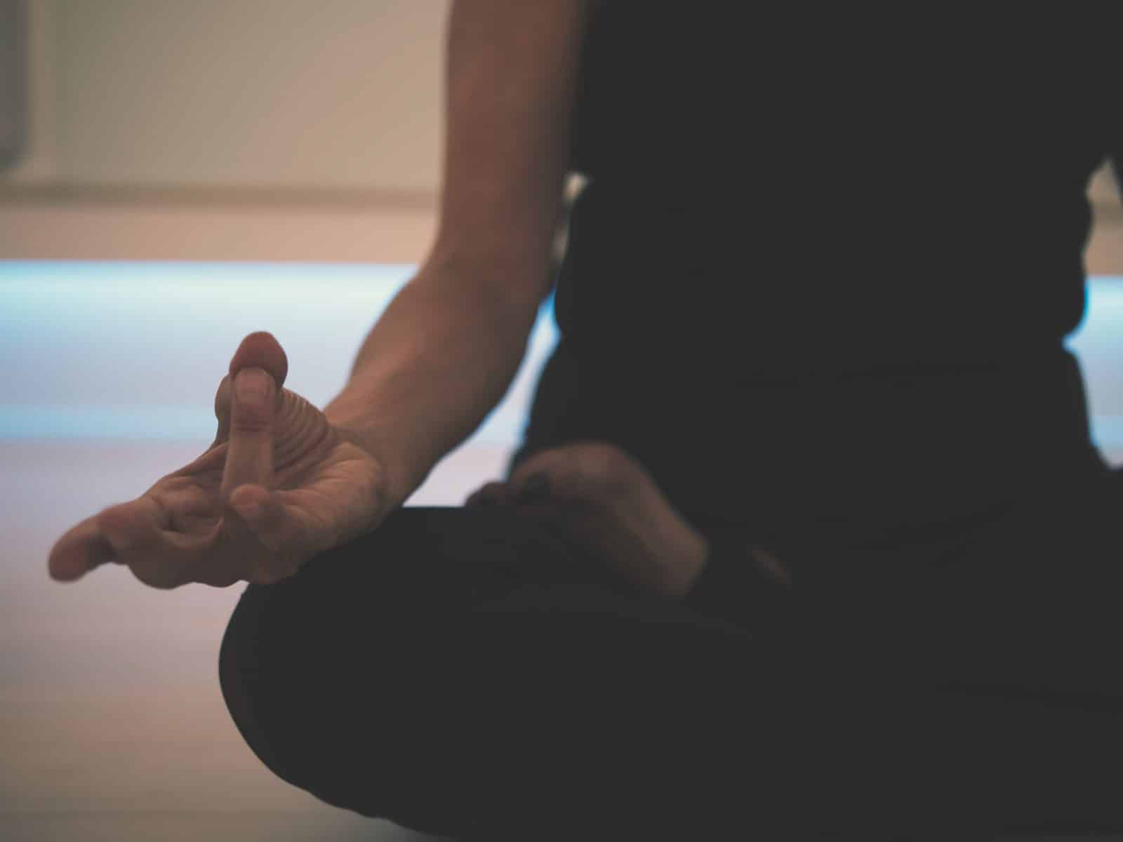 Meditation - person doing yoga on floor